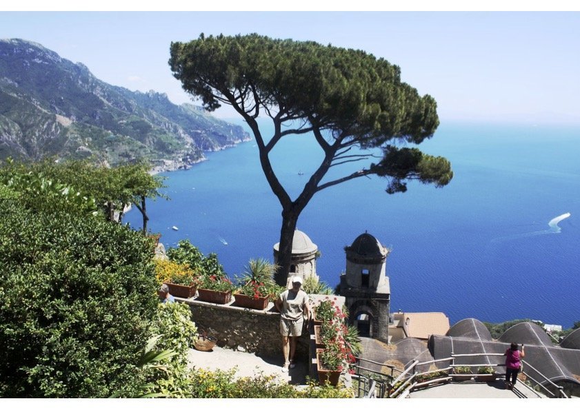 Tourists taking pictures against the backdrop of the Amalfi Coast landscape from the Villa Rufolo, Ravello (SA), Italy.